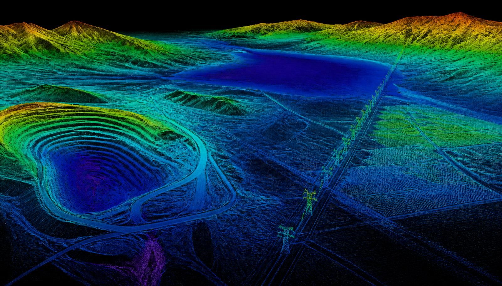 Nevada basin-and-range desert with an open-pit mine, dry lakebed, solar array, and transmission corridor rendered as a colorized aerial LiDAR point cloud