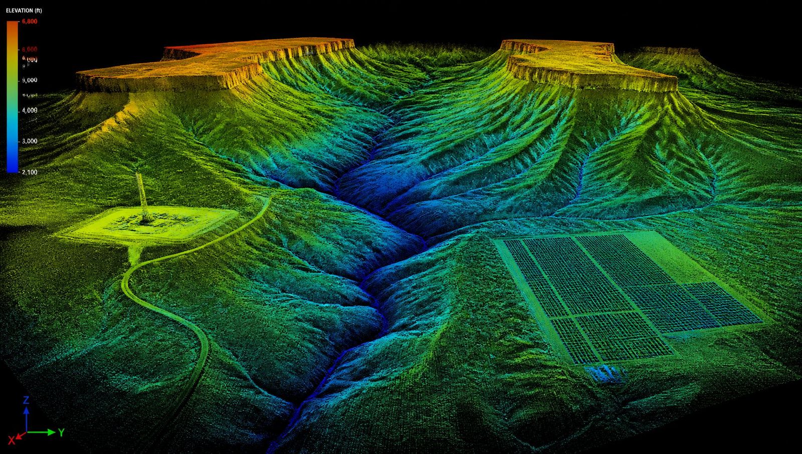 New Mexico high-desert mesas, a canyon cut by branching arroyos, an oil and gas well pad, and a utility-scale solar array rendered as a colorized aerial LiDAR point cloud