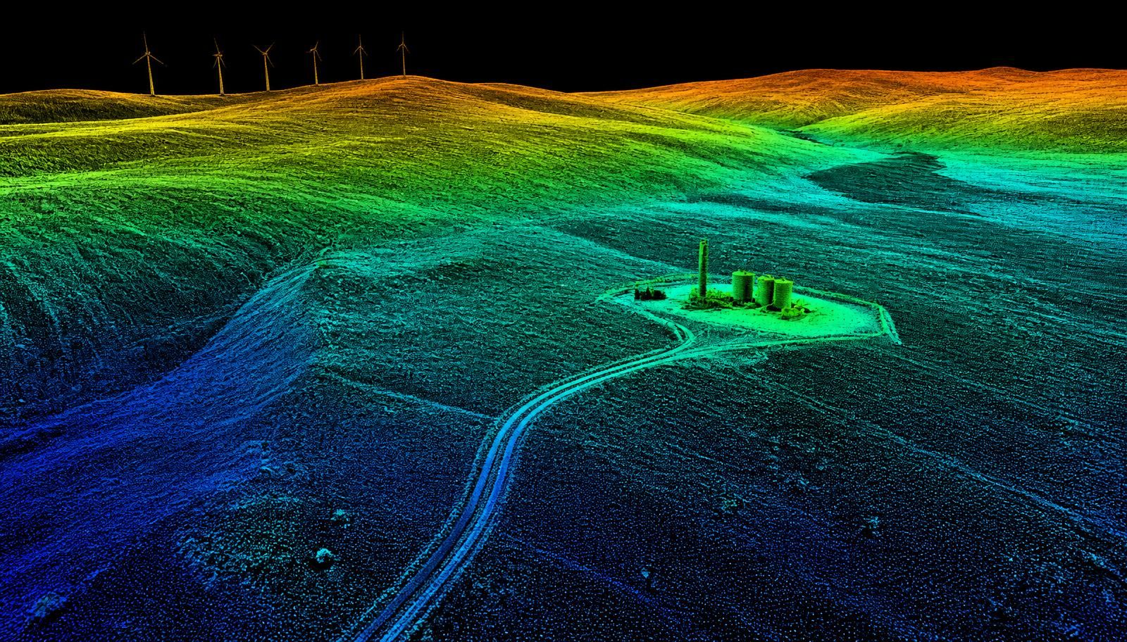 Wyoming high-plains terrain, a remote energy pad, and ridge-top wind turbines rendered as a colorized aerial LiDAR point cloud